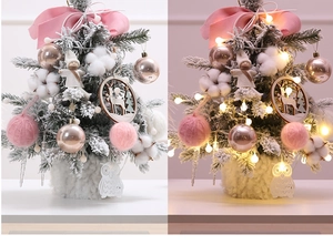 Close-up of pink mini Christmas tree with decorative baubles, owl cutout and LED lights