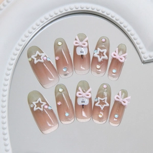 Handmade cat eye press-on nails with 3D pink bows and stars on pink gradient base