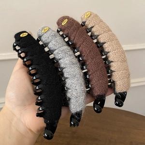 Set of four plush knitted banana hair clips with gold love tags in black, grey, brown, beige
