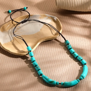 Handmade turquoise beaded necklace with adjustable brown cord in a vintage ethnic style