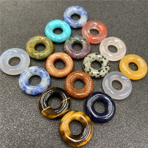 Assorted 20mm natural stone donut beads in a diamond grid layout for jewelry making