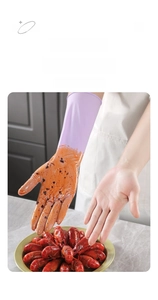 Detail showing lavender nitrile gloves protecting hands from oil while handling seafood