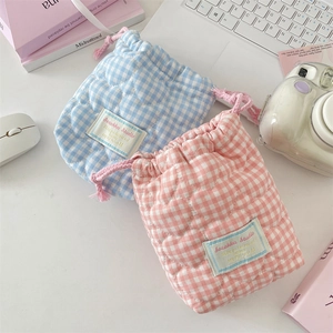 Detailed view of pink and blue quilted heart cotton pouches with soft drawstring closure