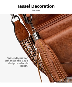 Detail of vintage brown bag featuring long tassels, ethnic woven strap and metal buckle