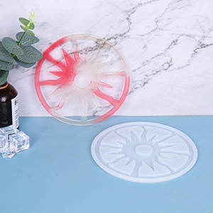 Detail view of round solar coaster silicone mold with red and white gradient resin finish