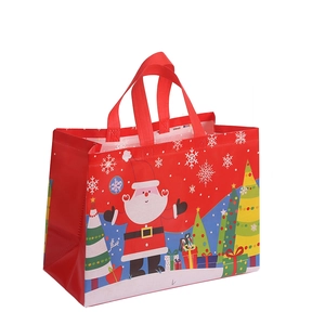 Red Christmas non-woven gift bag with Santa Claus, trees, and reinforced handles