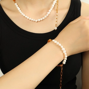 Elegant gold chain necklace and bracelet set with baroque pearls on model