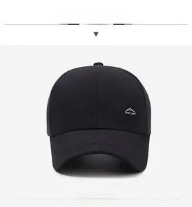 Detailed shot of black sport baseball cap with metal mountain logo and brim embroidery