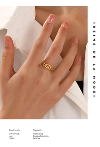 Close-up of elegant gold chain link ring worn by a model with a stylish aesthetic