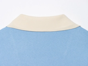 Detailed close-up of light blue knit shirt collar with premium cream texture