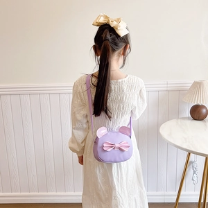Kids purple round crossbody bag with sequin bow and cute ears worn by a girl