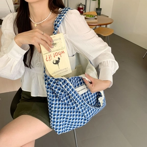 Detailed interior view of blue checkered tote bag with pockets for books and storage