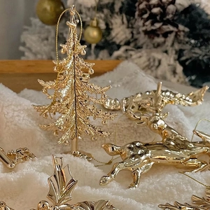 Exquisite gold Christmas ornaments featuring reindeer, tree, and holly leaf shapes