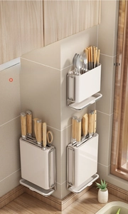Detail of wall-mounted kitchen organizer with cutlery holder and drainage tray