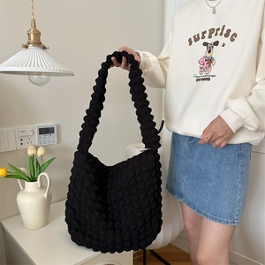 Detail of black bubble texture fabric and large capacity design of the hobo bag