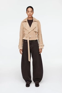 Close-up of beige suede short jacket with lapel collar and adjustable waist belt