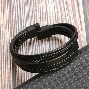 Close-up of double-layer braided black leather bracelet with sleek stainless steel clasp