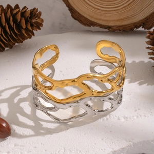 Irregular hollow geometric open bangle set in gold and silver finish on stone