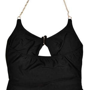 Detail of black halter dress featuring metallic chain straps and a hollow-out chest design
