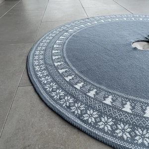 Dettaglio del tappeto per albero di Natale in maglia blu-grigio con fiocchi di neve