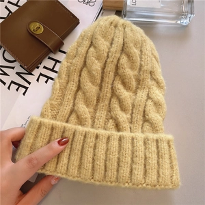 Macro detail of yellow cable knit beanie texture with stylish fashion lifestyle accessories