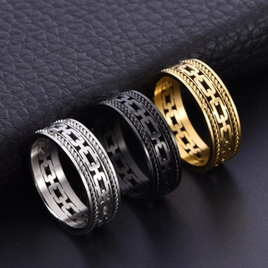 Cuban link steel cable ring in gold silver and black finishes on leather background