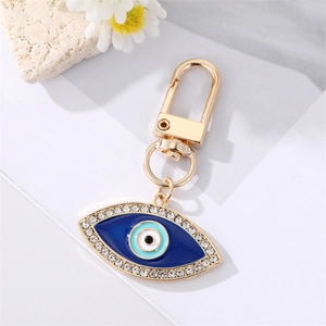 Detail of blue evil eye keychain with sparkling rhinestones and gold lobster clasp