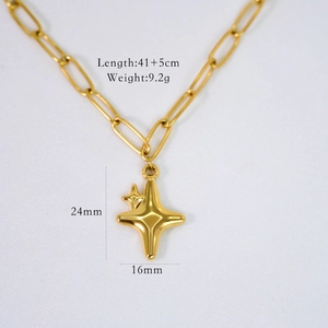 Close-up of gold paperclip chain necklace with starburst pendant and measurement data