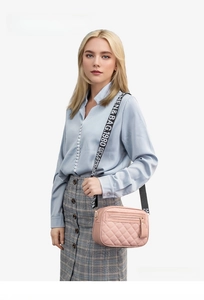 Pink quilted crossbody camera bag with adjustable letter print strap and zipper detail