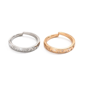 Close-up of adjustable hollow star rings with inlaid rhinestones in silver and rose gold