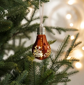 Bulb-shaped Christmas ornament with Merry Christmas text on a festive pine branch