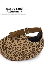 Detail of leopard print beret featuring adjustable dark brown matte strap and silver buckle