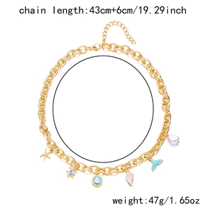 Detail of gold chain necklace with starfish, shell pendants and baroque pearl charms