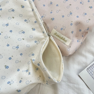 Detail of floral makeup bags showing fabric texture and premium zip closure