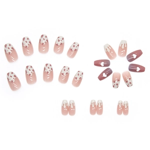 Pink press-on nails set with heart charms, cow patterns, and gradient short ballet shapes