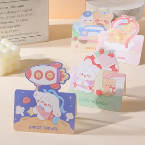 Close-up of cute cartoon animal cards featuring space, rainbow, and bear themes