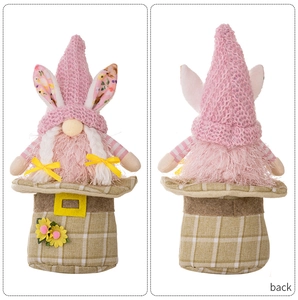 Front and back detail of pink Easter gnome with bunny ears and sunflower decoration