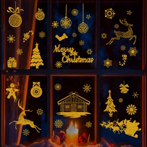 Detail of glitter gold Christmas window decals featuring Santa, reindeer and snowflakes