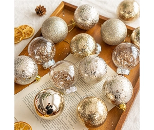 Flat lay of Christmas ornaments with gold and silver glitter balls on a wooden tray