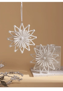 Macro detail of white glittery snowflake ornament with ribbon for Christmas tree decor