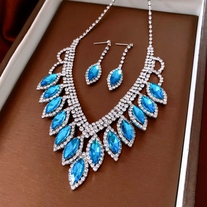 Close-up of elegant blue water-drop rhinestone necklace and earrings in a gift box