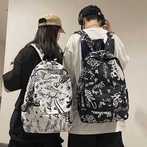 Detailed view of street style graffiti backpacks in black and white on male and female models
