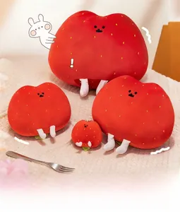 Three sizes of cute strawberry hash brown plush pillows shown together on soft fabric