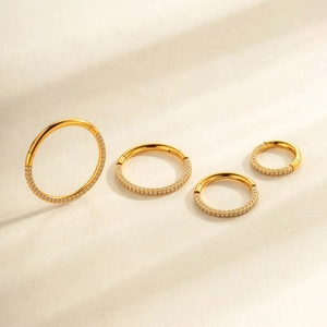 Golden G23 titanium hinged rings with pavé zircon stones in four different sizes