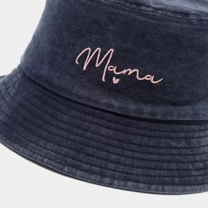 Close-up of pink Mama embroidery and fine stitching on a washed denim bucket hat