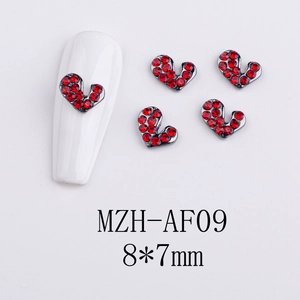 Macro shot of 8x7mm heart-shaped alloy nail charm with red rhinestones on white base