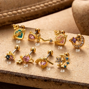 Set of eight gold cartilage earrings featuring colorful zircon heart and star designs