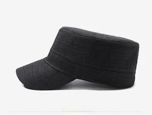 Detail view of dark grey cadet cap with twill texture and gold square metal buckle