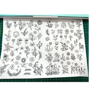 Close-up of Bohemian floral water-soluble embroidery stabilizer on a green cutting mat