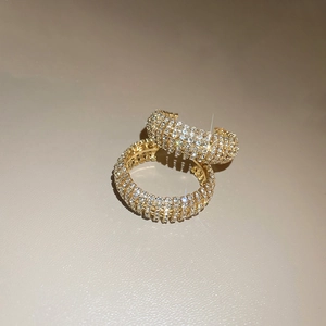 Elegant wide gold C-shaped hoop earrings with shimmering pavé crystal diamonds